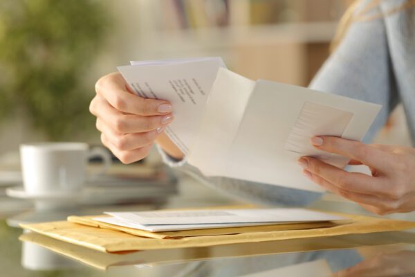 Woman opens letter from the IRS.